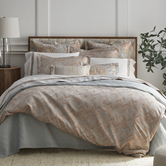 Alba Collection by Home Treasures featuring chevron-patterned duvet covers and shams, Natural White sateen sheeting with coordinating chevron accents, and Giverny Floral and Stria accent shams.
